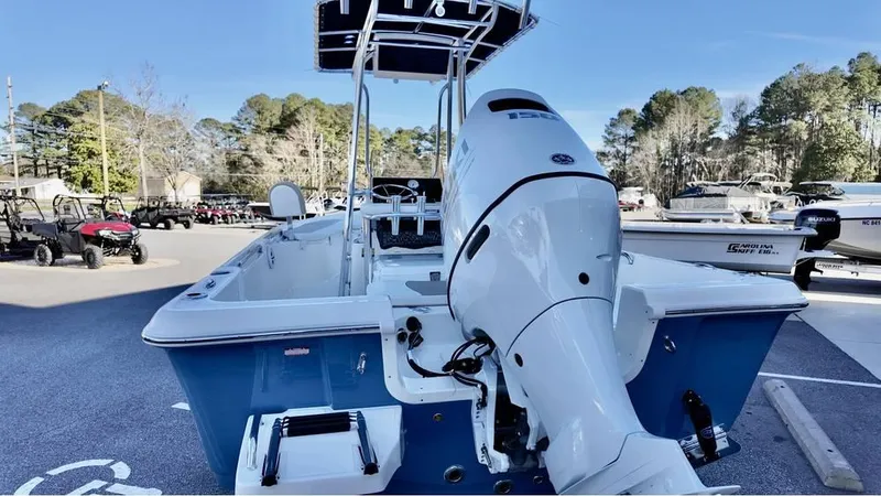 Slide: The Image of 2025 Bulls Bay 2200 XS boat with outboard motor, parked outdoors. - 5