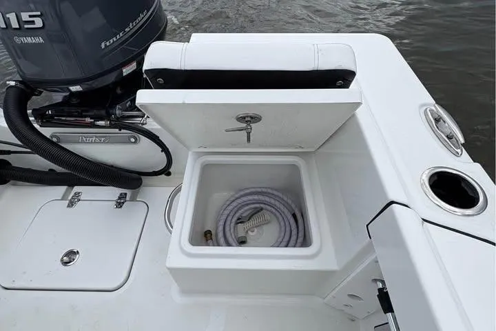 Slide: The Image of 2026 Parker 18SE Center Console boat with storage compartment and Yamaha engine. - 10