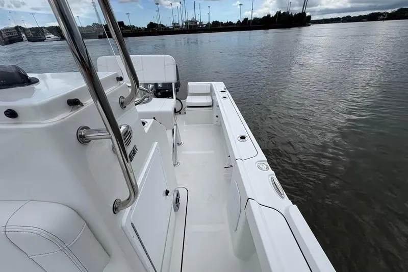 Slide: The Image of 2026 Parker 18SE Center Console boat on calm water, showcasing sleek design and spacious deck. - 11