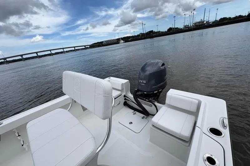 Slide: The Image of 2026 Parker 18SE Center Console boat on calm water, featuring a 115 horsepower engine. - 12