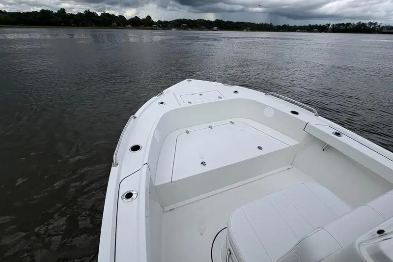 Slide: The Image of 2026 Parker 18SE Center Console boat on calm water under cloudy skies. - 15