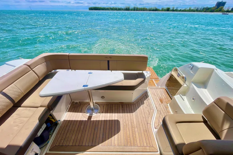 Slide: The Image of 2017 Sea Ray Sundancer 400 yacht with elegant seating and table on a sunny day. - 10