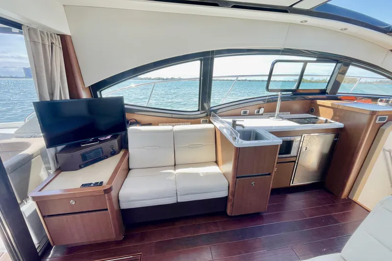 Slide: The Image of Interior of 2017 Sea Ray Sundancer 400 yacht with kitchenette and seating area. - 12