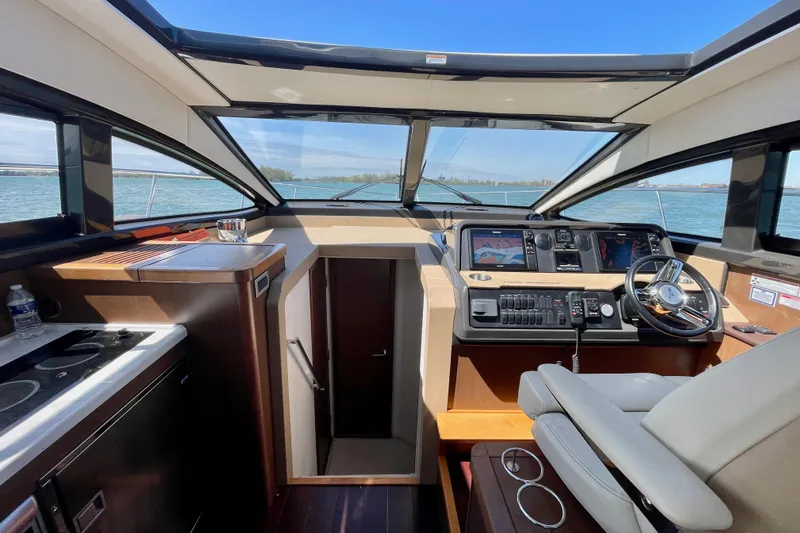 Slide: The Image of Interior view of 2017 Sea Ray Sundancer 400 yacht cockpit with modern controls and panoramic windows. - 15