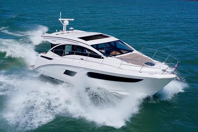 Slide: The Image of 2017 Sea Ray Sundancer 400 yacht cruising on open water, creating waves. - 2