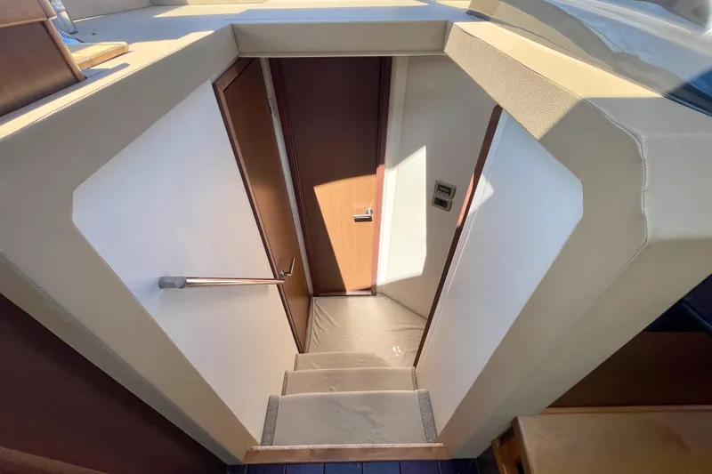 Slide: The Image of Stairway inside 2017 Sea Ray Sundancer 400 yacht, featuring sleek design and wooden door. - 20