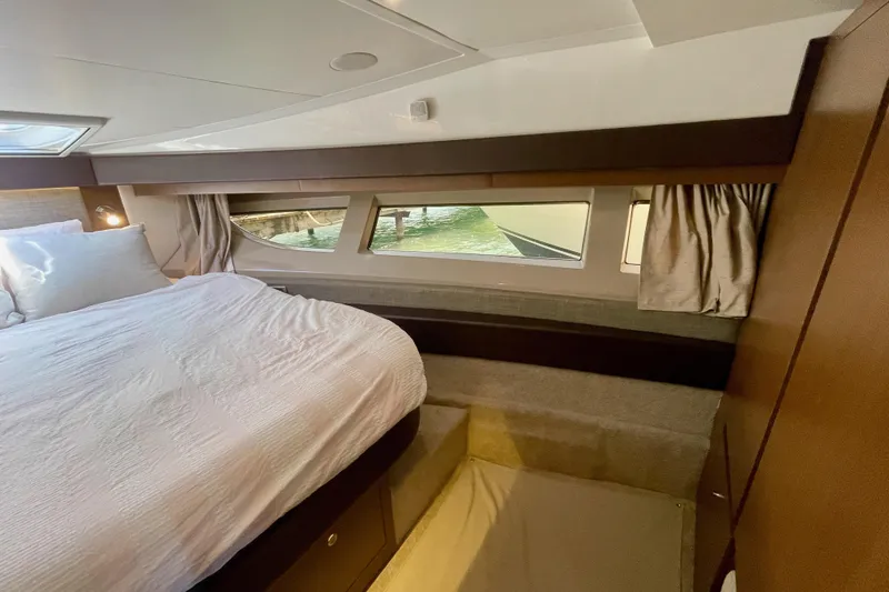 Slide: The Image of Luxurious cabin interior of 2017 Sea Ray Sundancer 400 yacht with large bed and windows. - 26