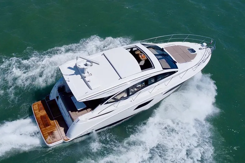 Slide: The Image of 2017 Sea Ray Sundancer 400 yacht cruising on open water, aerial view. - 4
