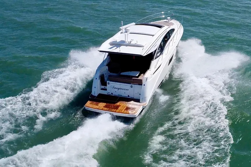 Slide: The Image of 2017 Sea Ray Sundancer 400 cruising on open water, rear view. - 6