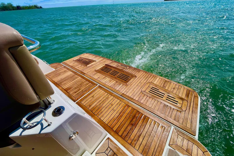 Slide: The Image of 2017 Sea Ray Sundancer 400 with teak swim platform on open water. - 8
