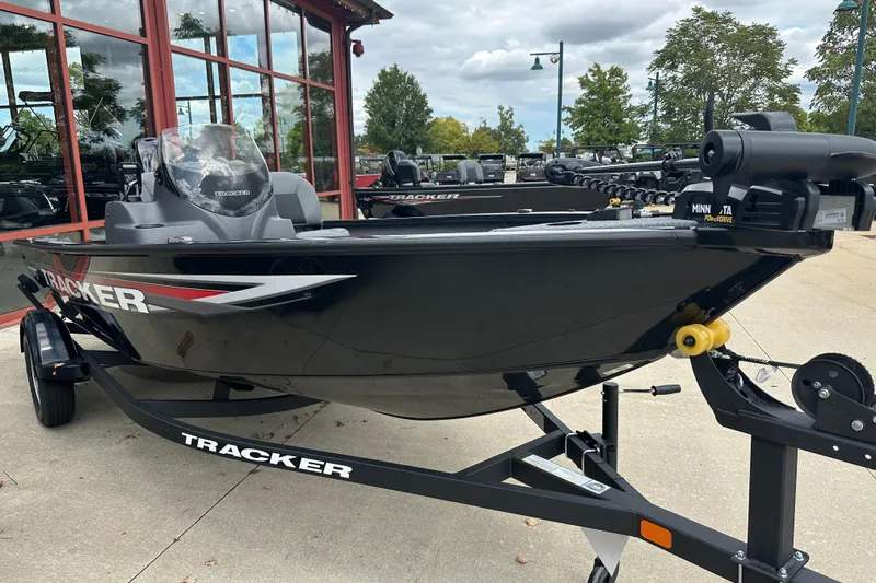Slide: The Image of 2026 Tracker Super Guide V-16 SC boat on trailer, parked outdoors. - 2