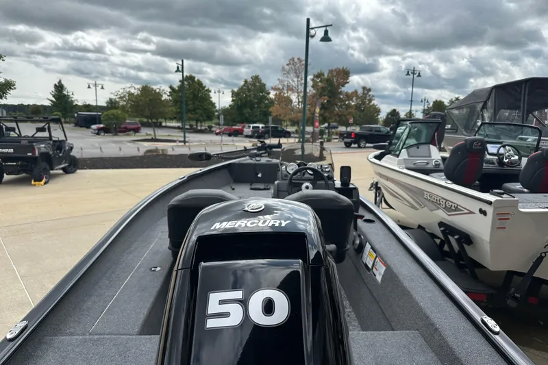 Slide: The Image of 2026 Tracker Super Guide V-16 SC boat with Mercury 50 engine in a parking lot. - 3