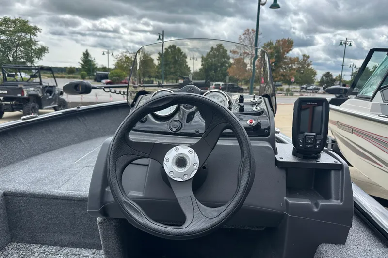 Slide: The Image of 2026 Tracker Super Guide V-16 SC boat dashboard with steering wheel and Garmin device. - 4