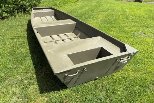 Slide: The Image of 2026 Tracker Grizzly 14 Jon boat on grass, showcasing its sturdy aluminum build. - 4