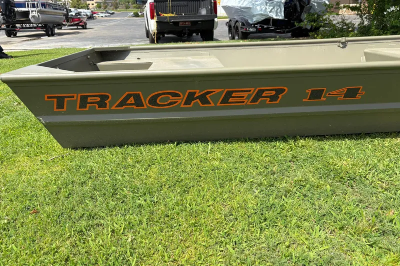 Slide: The Image of 2026 Tracker Grizzly 14 Jon boat on grass, showcasing bold orange lettering. - 6