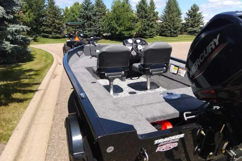 Slide: The Image of 2026 Tracker Super Guide V-16 SC boat with Mercury engine on a sunny day. - 3