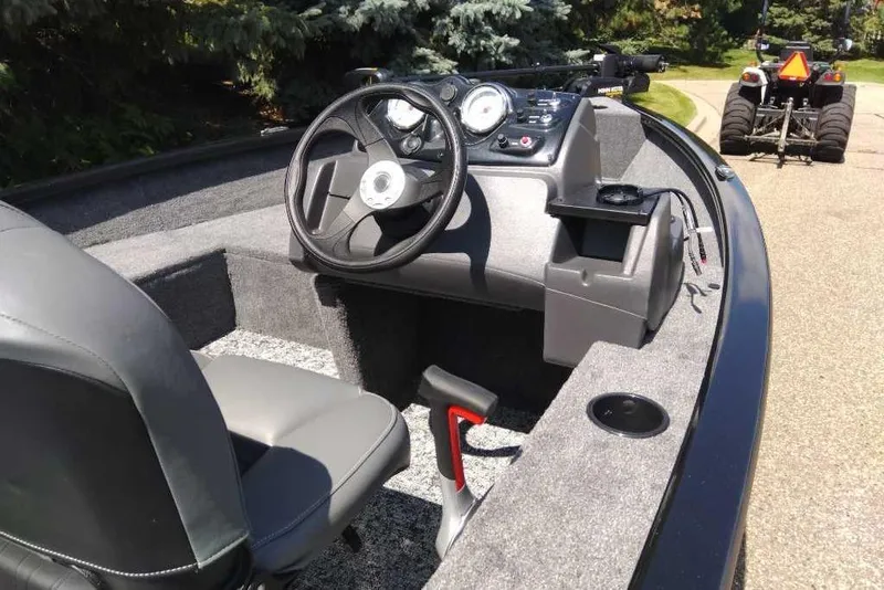 Slide: The Image of 2026 Tracker Super Guide V-16 SC boat interior with steering wheel and dashboard controls. - 4