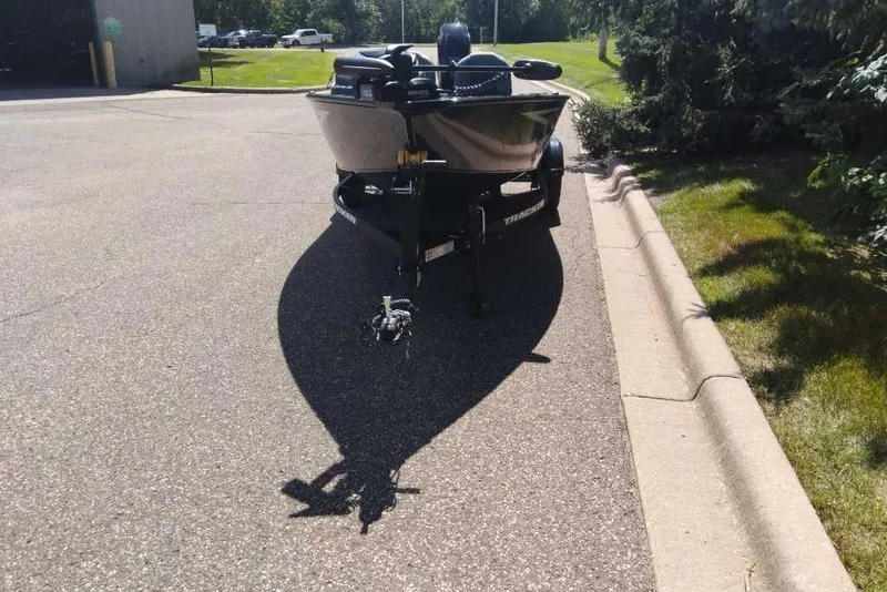 Slide: The Image of 2026 Tracker Super Guide V-16 SC boat parked on a sunny street. - 5