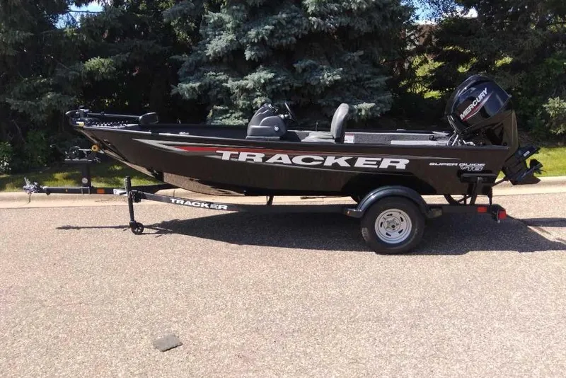 Slide: The Image of 2026 Tracker Super Guide V-16 SC boat on trailer, parked outdoors. - 7