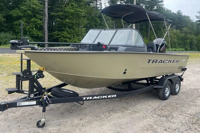 Slide: The Image of 2026 Tracker Targa V-18 Combo boat on trailer, parked outdoors with forest background. - 3