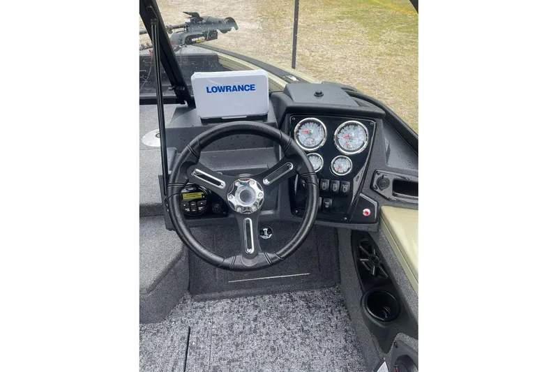 Slide: The Image of 2026 Tracker Targa V-18 Combo boat dashboard with steering wheel and Lowrance display. - 7