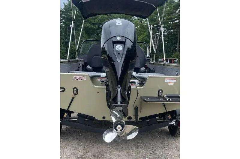 Slide: The Image of 2026 Tracker Targa V-18 Combo boat with outboard motor, parked outdoors. - 9