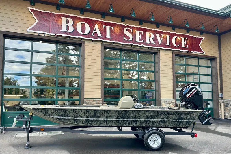 The Image of 2026 Tracker Grizzly 1648 SC boat outside a boat service center. - 0