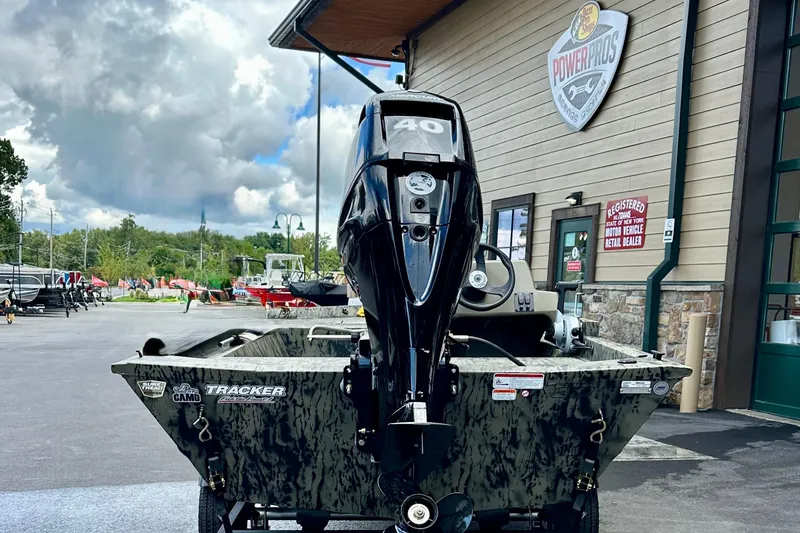 Slide: The Image of 2026 Tracker Grizzly 1648 SC boat with motor, parked outside dealership. - 3