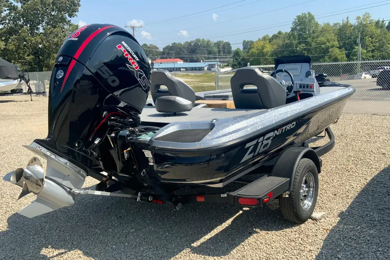 Slide: The Image of 2026 Nitro Z18 Pro boat with powerful engine, parked on gravel lot. - 2