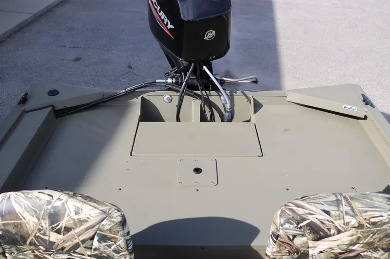 Slide: The Image of 2026 Tracker Grizzly 1754 SC boat with Mercury outboard motor, camo seats, and spacious deck. - 8