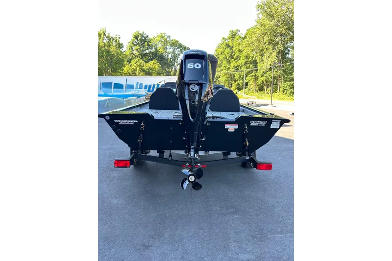 Slide: The Image of 2026 Tracker Pro Team 175 boat with 60 HP engine, parked outdoors. - 2