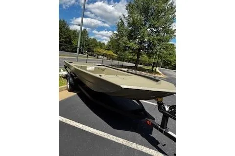 Slide: The Image of 2026 Tracker Grizzly 1754 Utility boat on trailer in parking lot. - 3