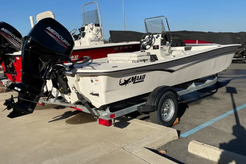 Slide: The Image of 2026 Mako Pro Skiff 17 CC boat on trailer with Mercury outboard motor. - 1