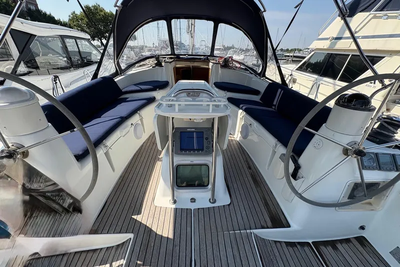 Slide: The Image of 2007 Jeanneau Sun Odyssey 42 DS cockpit with dual steering wheels and blue seating. - 12