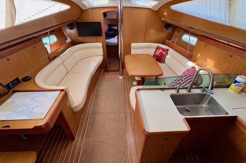 Slide: The Image of Interior of 2007 Jeanneau Sun Odyssey 42 DS yacht with elegant seating and kitchen area. - 17