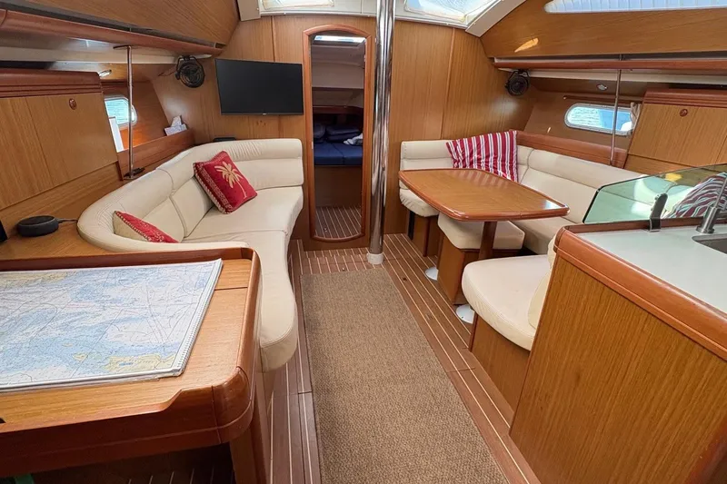 Slide: The Image of Interior of 2007 Jeanneau Sun Odyssey 42 DS yacht with cozy seating and wooden finishes. - 19