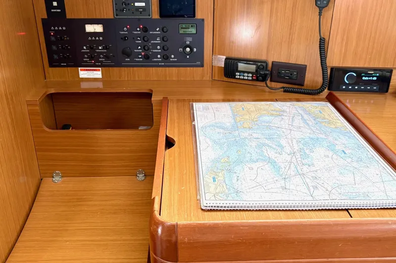 Slide: The Image of Navigation station of 2007 Jeanneau Sun Odyssey 42 DS with map and control panel. - 25