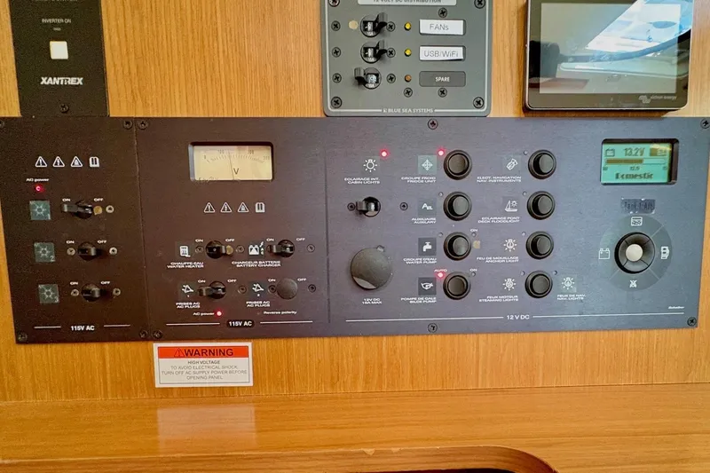 Slide: The Image of Control panel of a 2007 Jeanneau Sun Odyssey 42 DS sailboat, featuring various switches and gauges. - 26