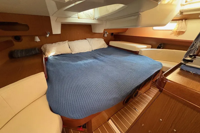 Slide: The Image of Cozy cabin interior of 2007 Jeanneau Sun Odyssey 42 DS with blue bedding. - 33