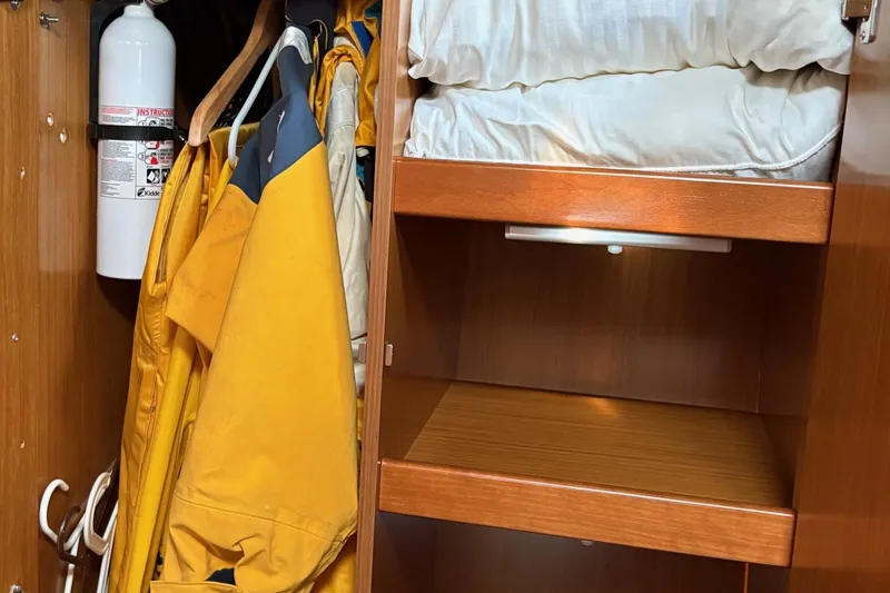 Slide: The Image of Cabin closet in 2007 Jeanneau Sun Odyssey 42 DS with rain gear and fire extinguisher. - 36