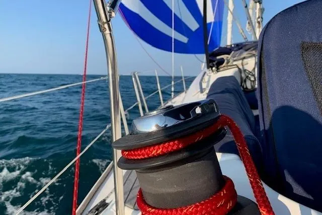 Slide: The Image of 2007 Jeanneau Sun Odyssey 42 DS sailboat with red rope on winch, sailing on open sea. - 4