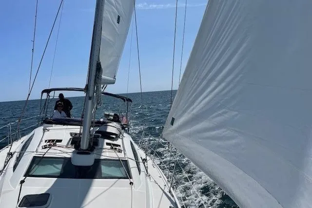 Slide: The Image of 2007 Jeanneau Sun Odyssey 42 DS sailing on open sea under clear blue sky. - 8