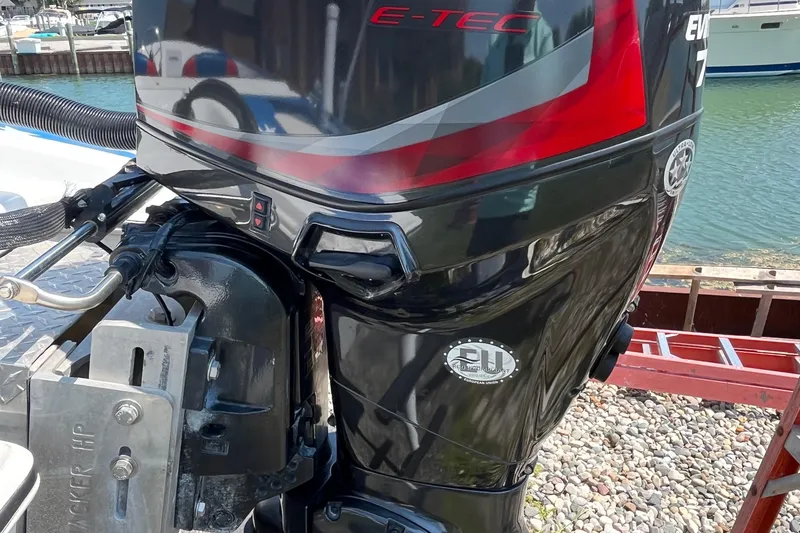 Slide: The Image of 2021 Patriot outboard motor by the water, featuring E-TEC technology. - 7