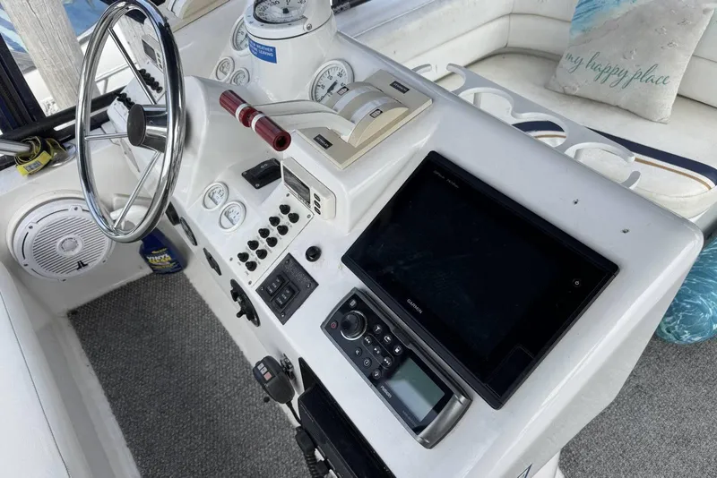 Slide: The Image of 1998 Mainship 31 Sedan Bridge helm with steering wheel, gauges, and navigation equipment. - 10