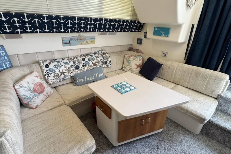 Slide: The Image of Cozy interior of 1998 Mainship 31 Sedan Bridge with nautical-themed decor and comfortable seating. - 15
