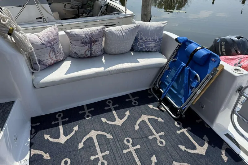 Slide: The Image of 1998 Mainship 31 Sedan Bridge boat interior with nautical-themed decor and seating. - 7