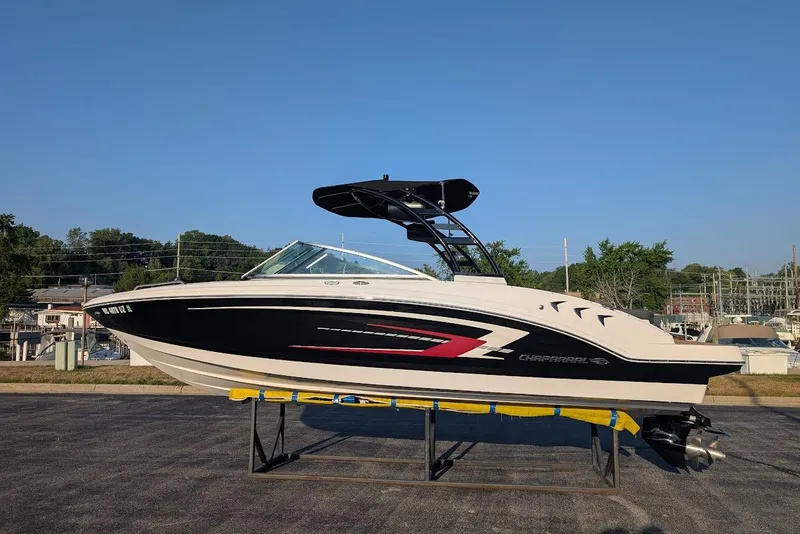 The Image of 2023 Chaparral 23 SSi boat on display, black and white design, outdoor setting. - 0