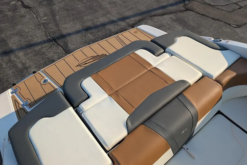 Slide: The Image of 2023 Chaparral 23 SSi boat with stylish brown and white seating on deck. - 13