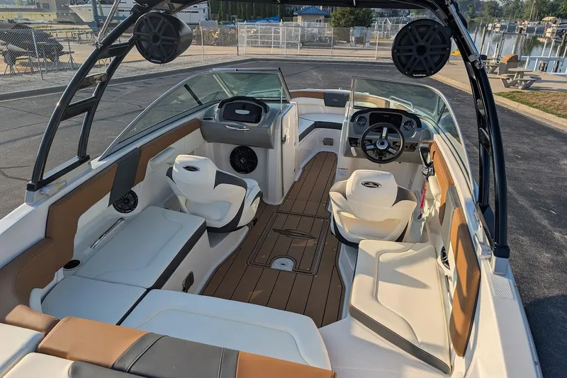 Slide: The Image of 2023 Chaparral 23 SSi boat interior with seating, steering wheel, and speakers. - 14