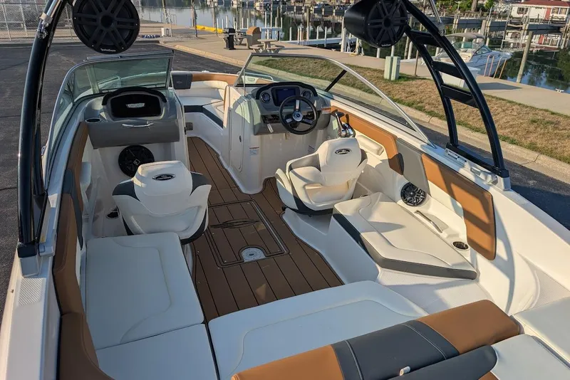 Slide: The Image of 2023 Chaparral 23 SSi boat interior with sleek seating and modern dashboard design. - 15